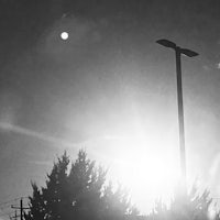 a black and white photo of a street light